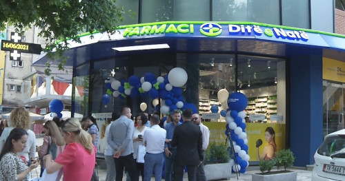 A street scene in Tirana, Albania. The sign over the shop door reads "Farmaci Ditë e Natë", meaning "Day and Night Pharmacy" in Albanian. 