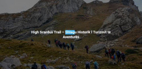  Hikers walking on a narrow trail through the mountains. A caption in white text, overlaid on the photograph, reads "High Scardus Trail - Shtegu Historik i Turizmit të Aventurës", which is Albanian for "Historic Adventure Tourism Trail". 
